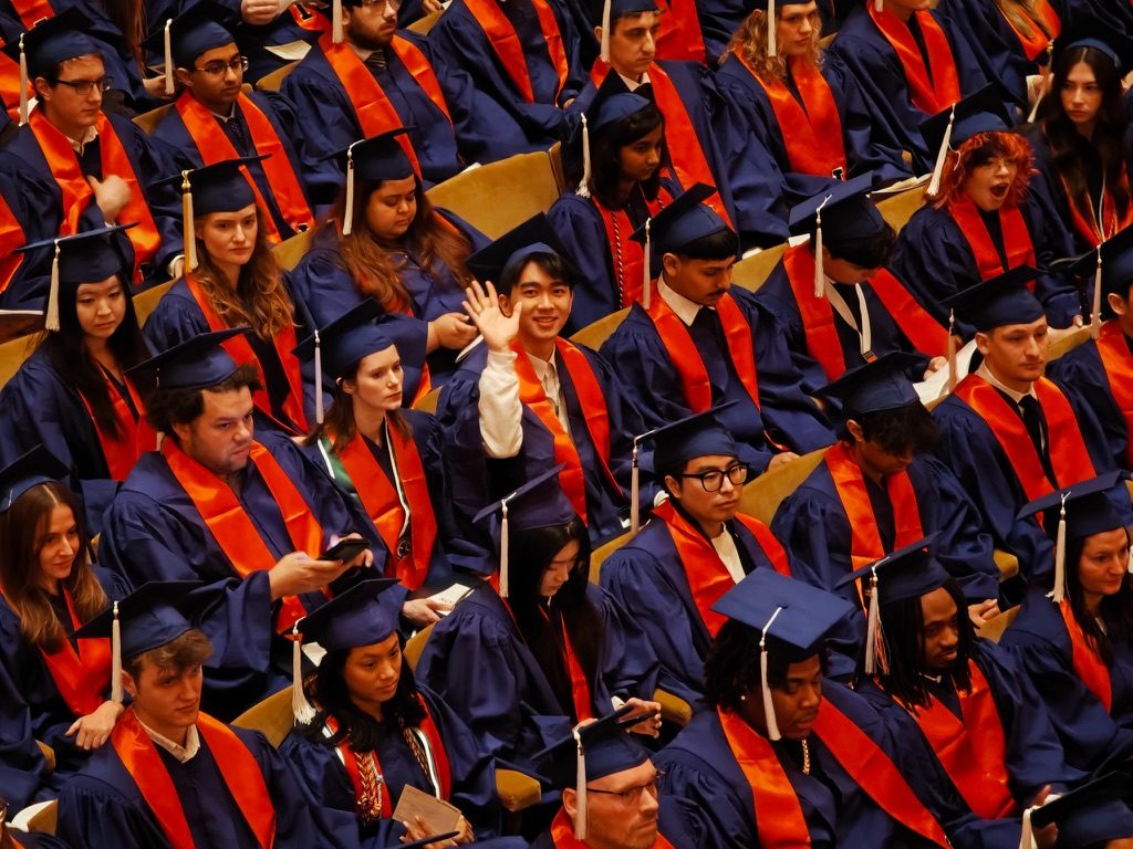 Waving at graduation ceremony